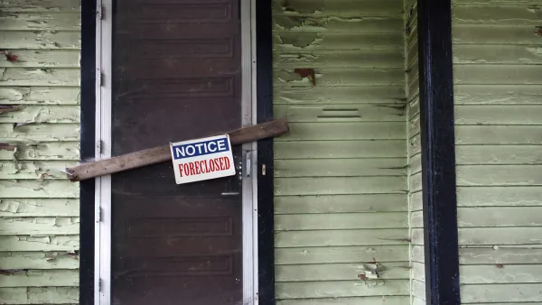 Vacant home with foreclosure sign.